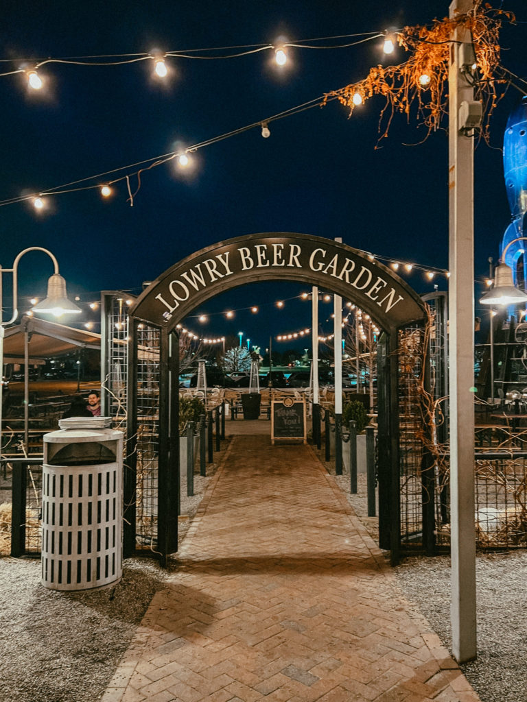 Lowry Beer Garden, one of the best date night restaurants in Denver lit up at night.