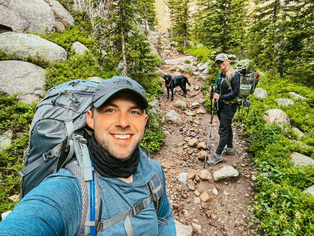 Abby, Sam, and Clover backpacking in Colorado with the best backpacking pillow for side sleepers in their gear.