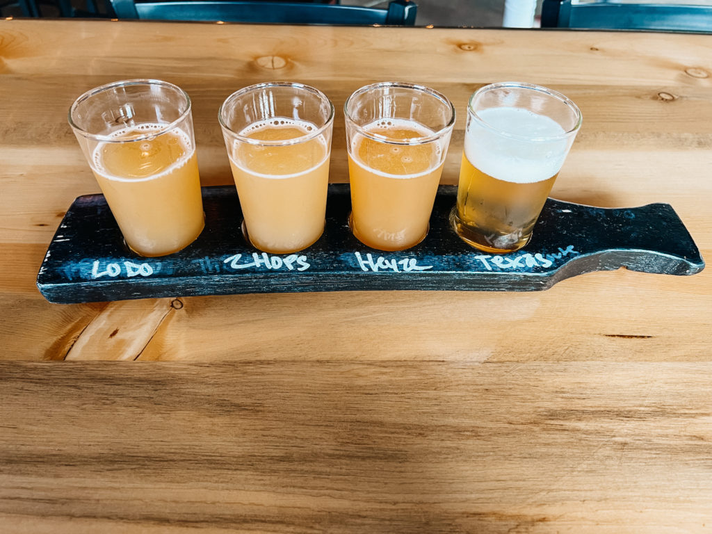 A flight of hazy beers served at the table.