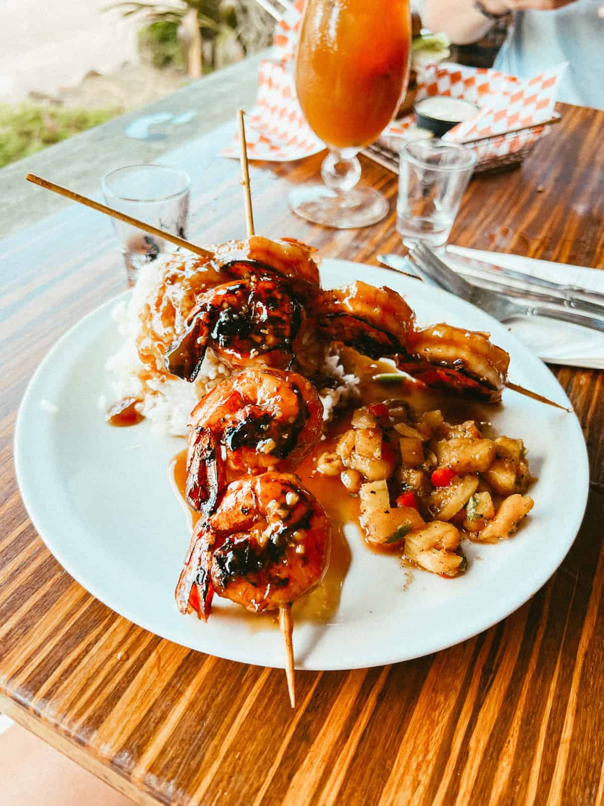 Grilled shrimp skewers with rice at one of the best restaurants you need to try on your 7 day Kauai itinerary!