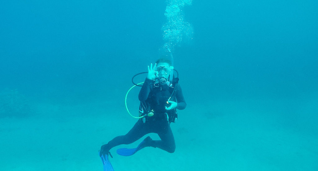 Abby scuba diving in the ocean on the best 7 day Kauai itinerary!