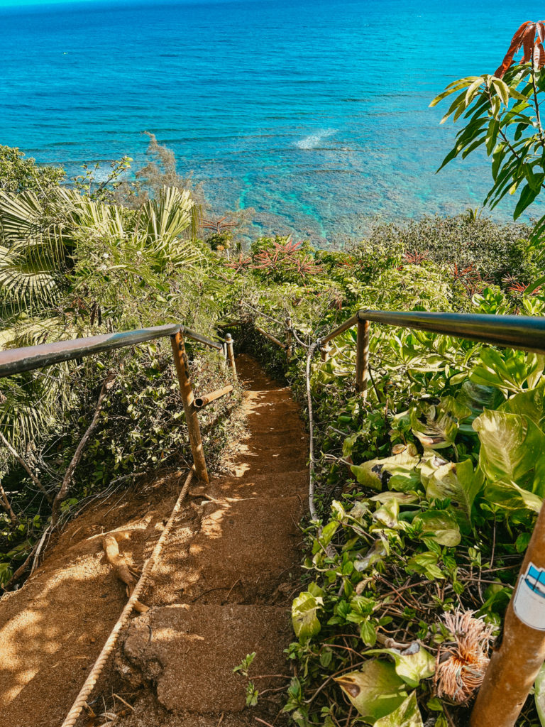 A steep stairway hike leading down to Hideaway Beach, a must see beach on your 7 day Kauai itinerary!