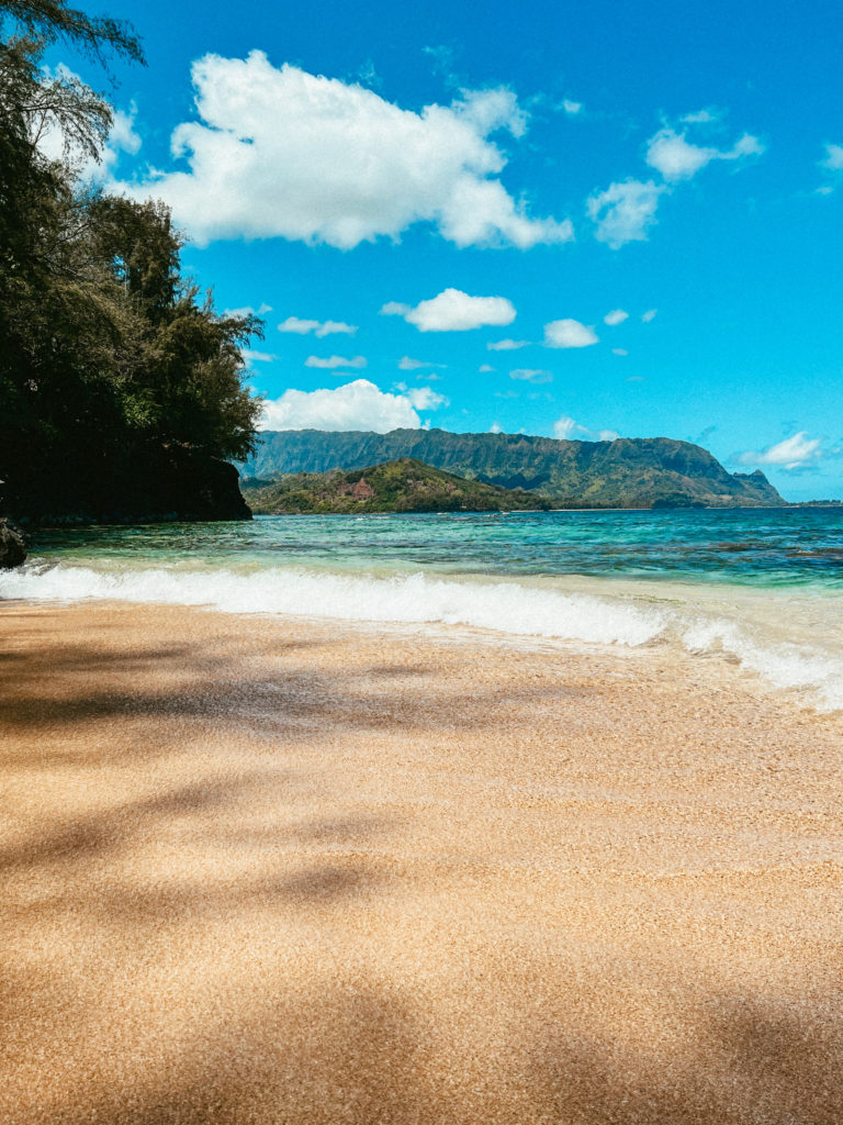A beach in Kauai as the waves roll in.