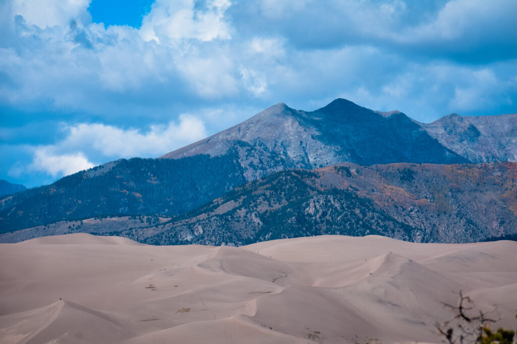 Great Sand Dunes National Park with mountains behind the sand dunes as clouds roll in.