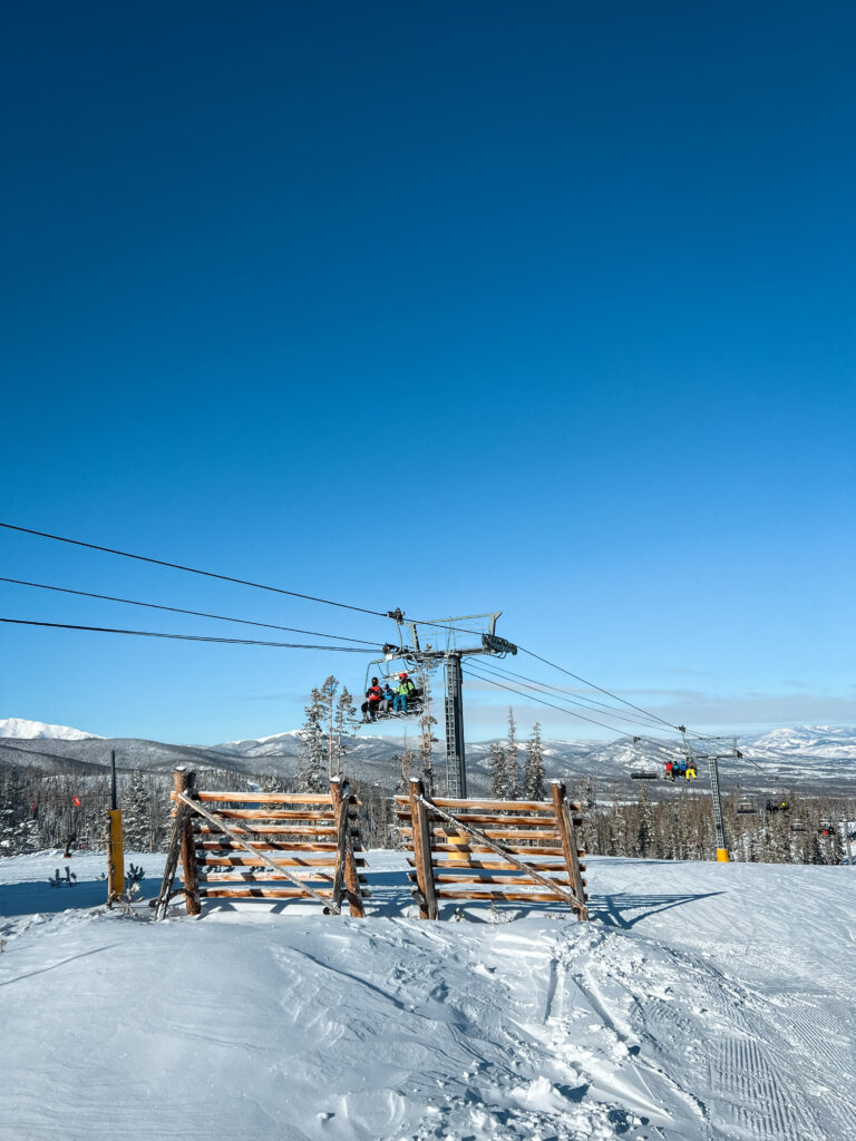 A ski lift in Colorado with blue skies up above.