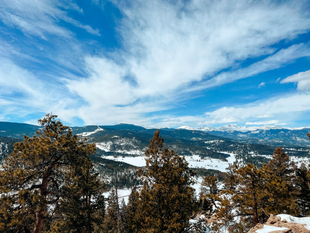 Snowy mountain views with partly cloudy skies on a hike in Colorado.