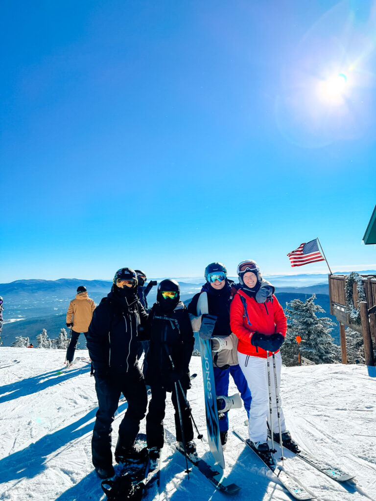 A group of friends skiing in Vermont on a bluebird day.