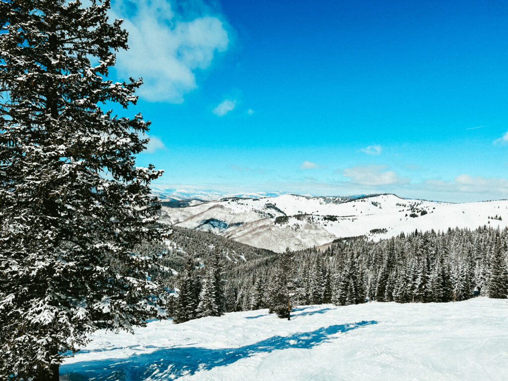 Colorado winter vacations for non skiers at a mountain town with beautiful snow capped mountains in the distance.