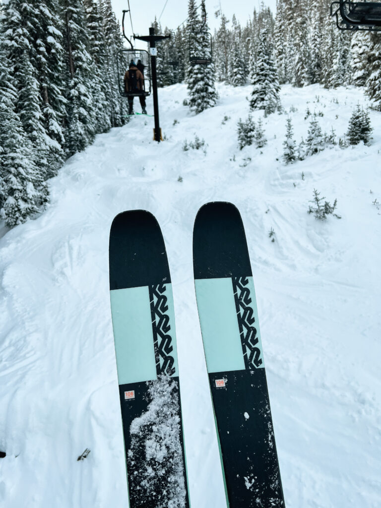 K2 skis on a lift with some of the best ski boots for wide calves.