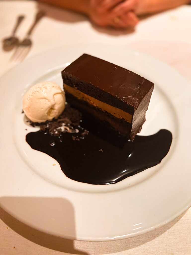 A delicious chocolate dessert served with ice ceam.