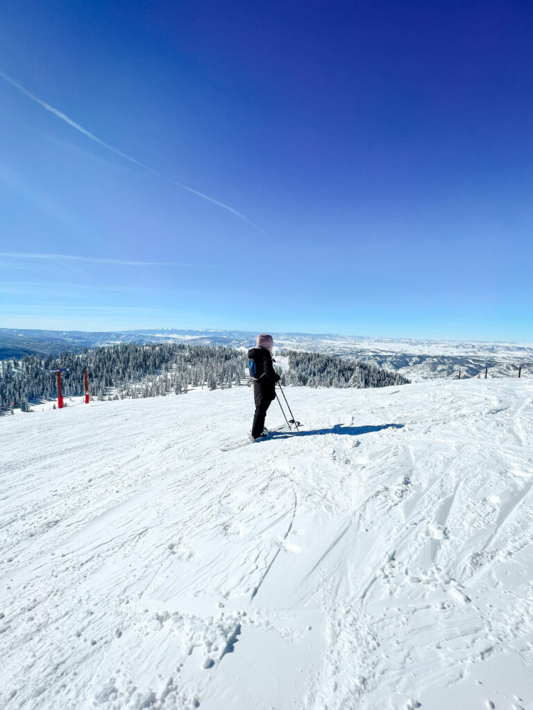 Abby skiing in Colorado with blue skies and plenty of snow.