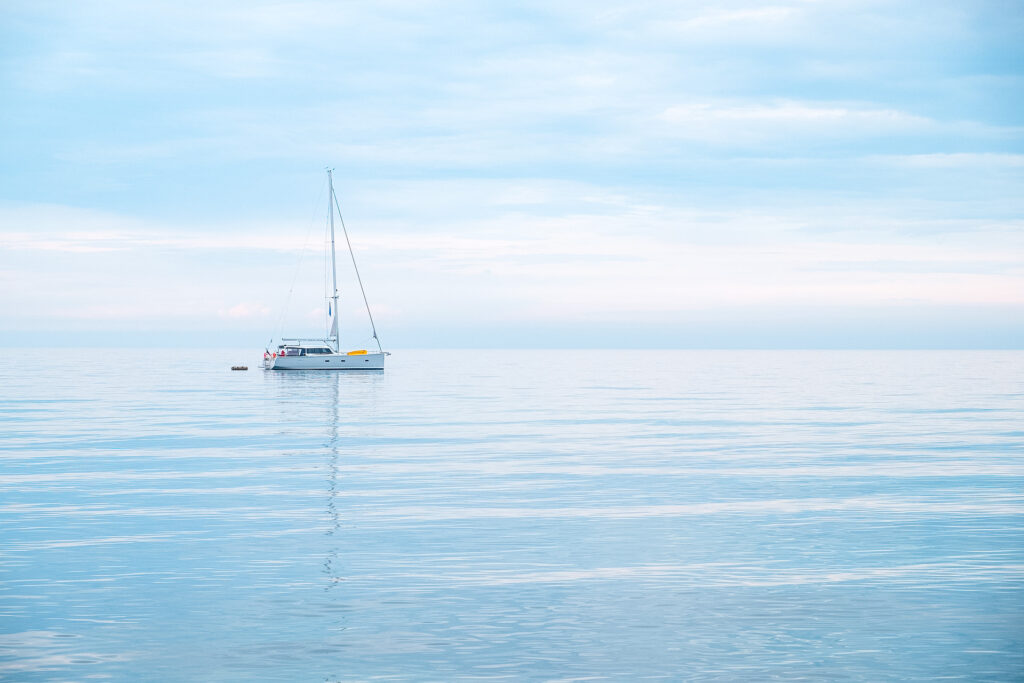 A sailboat floating in the open water.
