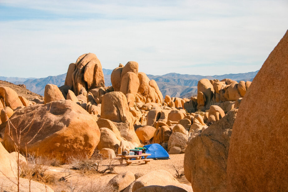 One of the best tents for desert camping set up near rocks.