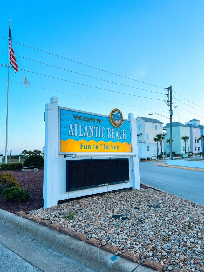 The welcome sign at Atlantic Beach with blue skies in the background.