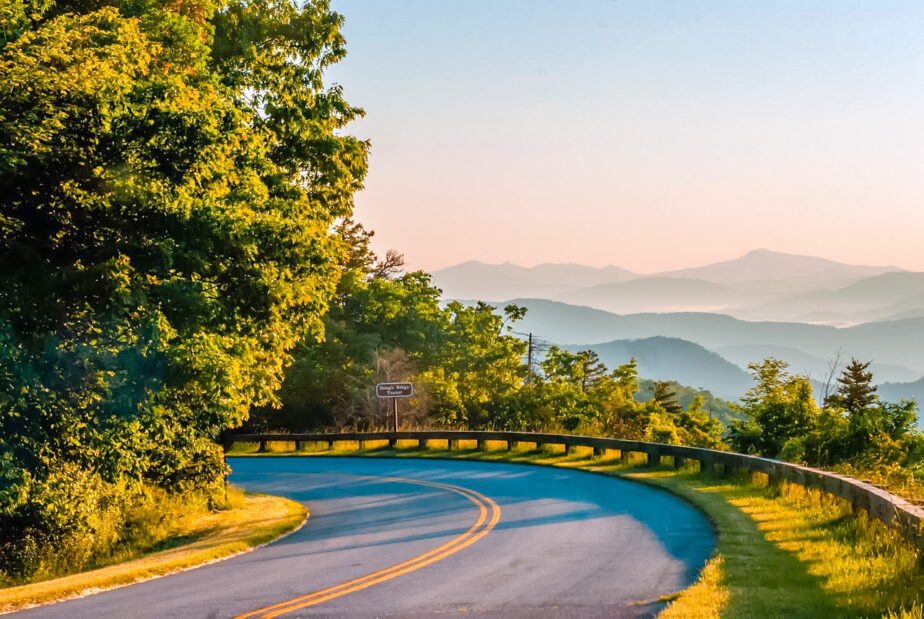 A road near Asheville with mountains in the distance.