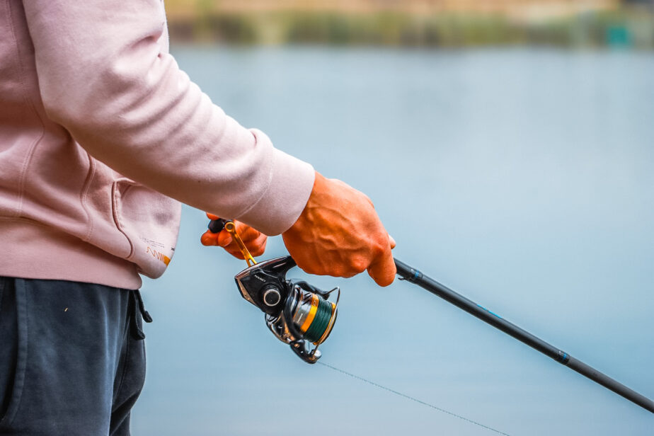 Someone fishing on water with one of the best surf fishing reels.