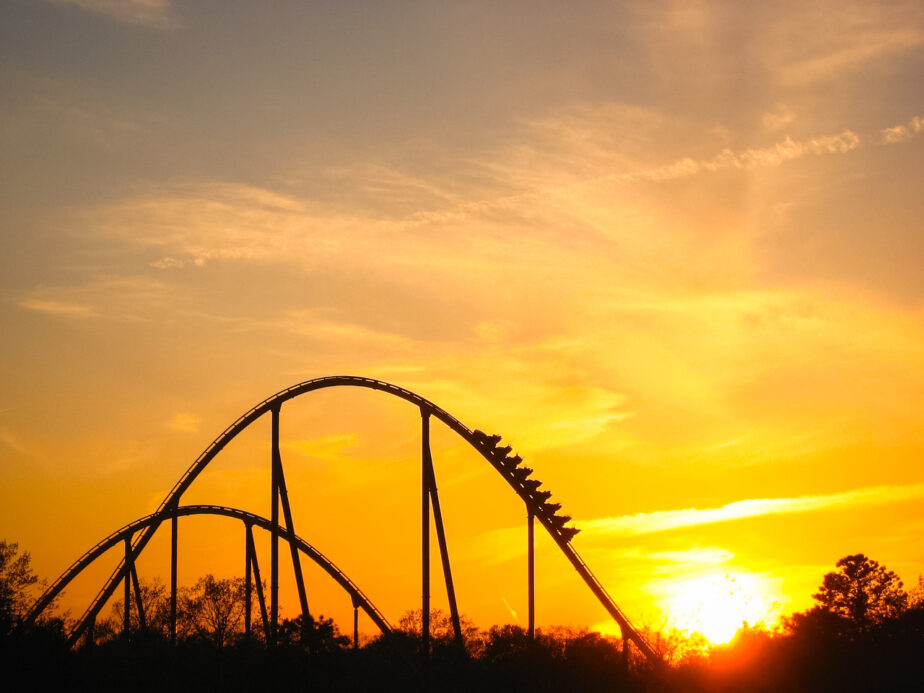 A roller coast at an amusement park as the sun sets.