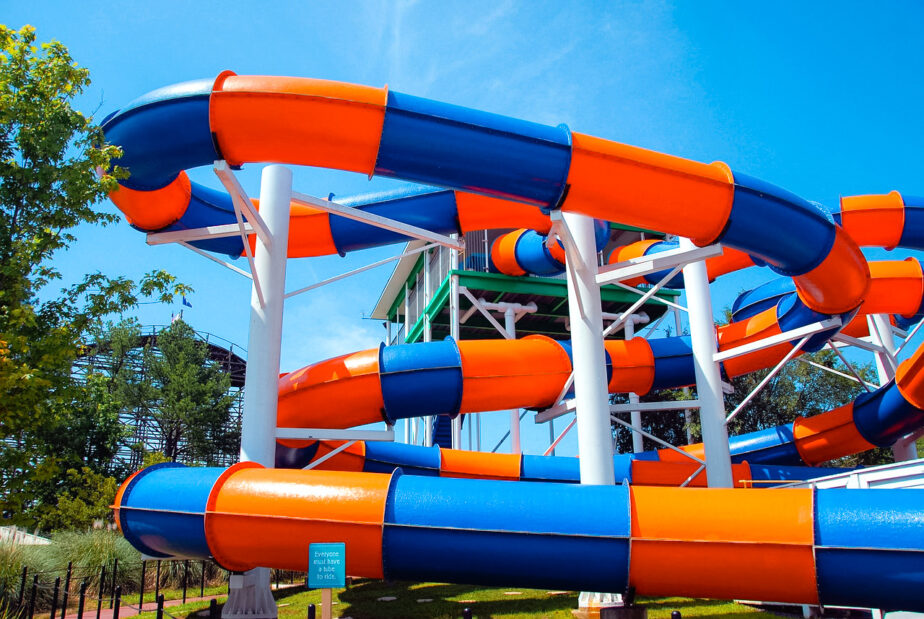 A colorful waterpark slide with blue skies in the distance.