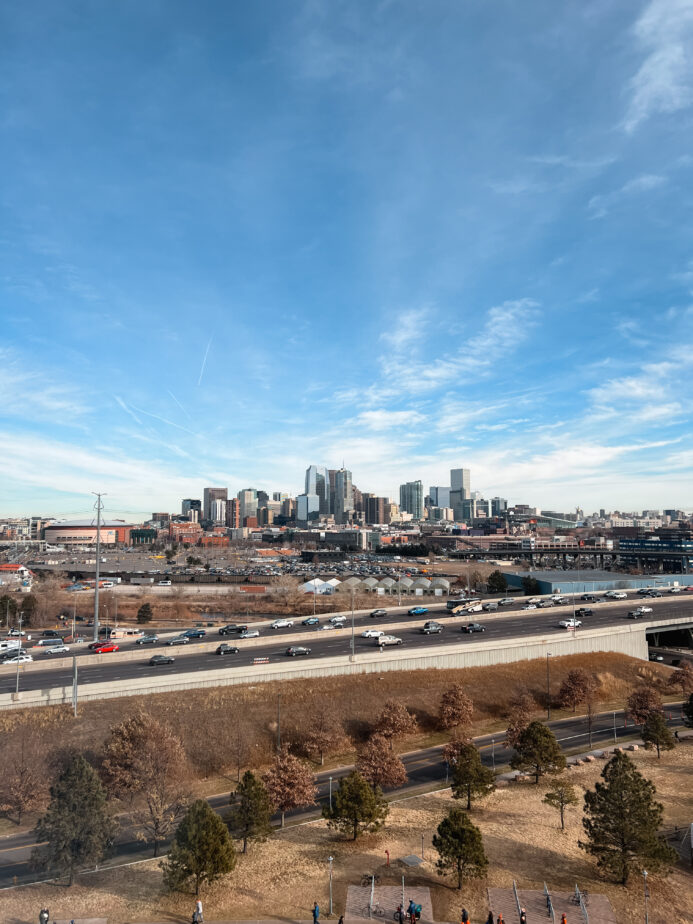 A skyline view of the city of Denver with blue skies up above.