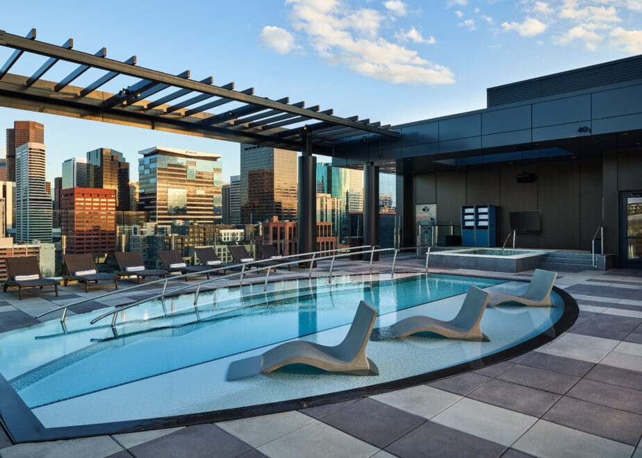 The Rally Hotel at McGregor Square's rooftop pool with skyline views of the city of Denver.