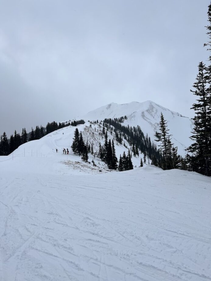 Ski mountain with snow and grey skies.