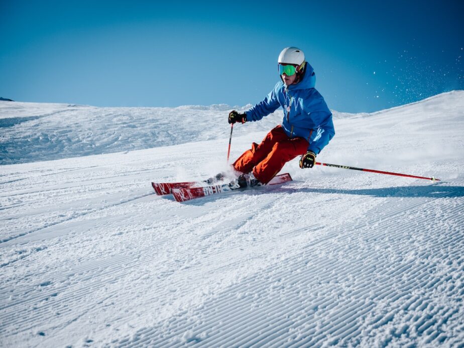A skier going down a groomed run. 