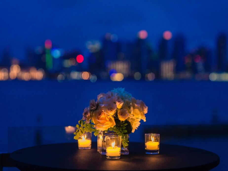 A candlelight dinner with the skyline in the background.