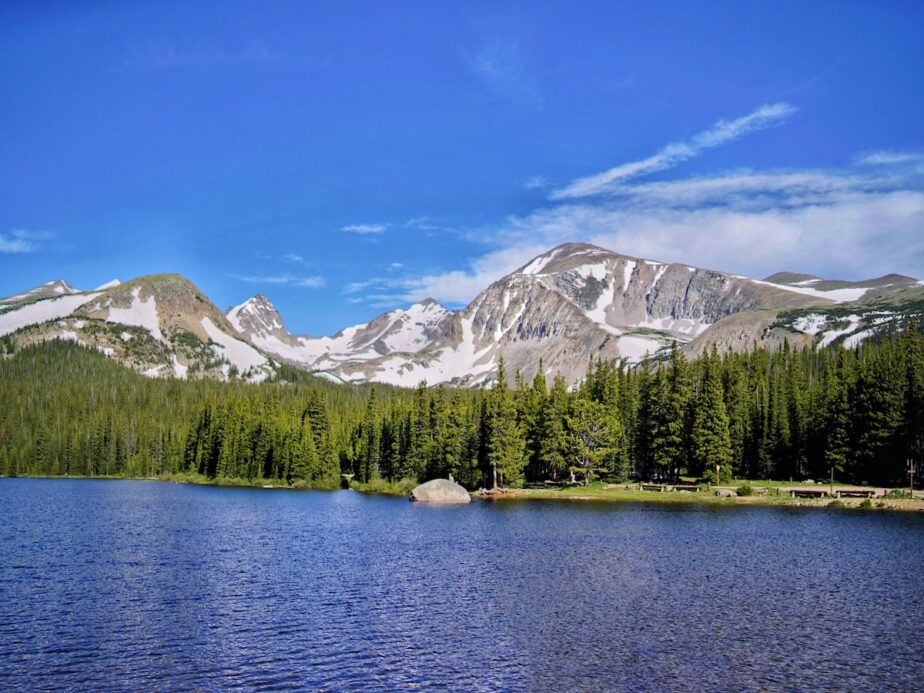 A hike in Colorado with a lake, forested area, and mountain views.