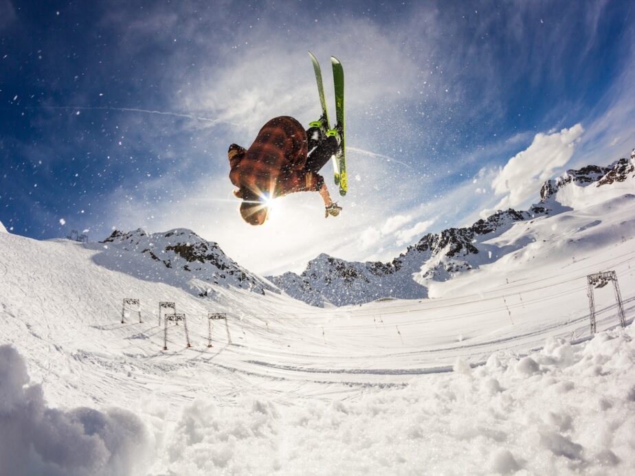 A skier doing a trick on the slopes.