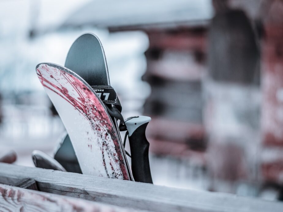 Skis leaning up against wood.