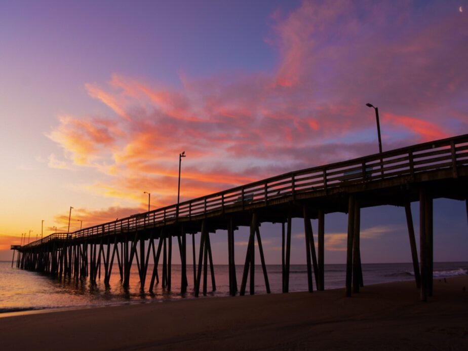 A pier in Virginia Beach during sunset.