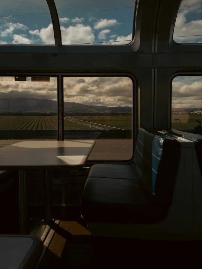 A train seat with mountains in the distance.