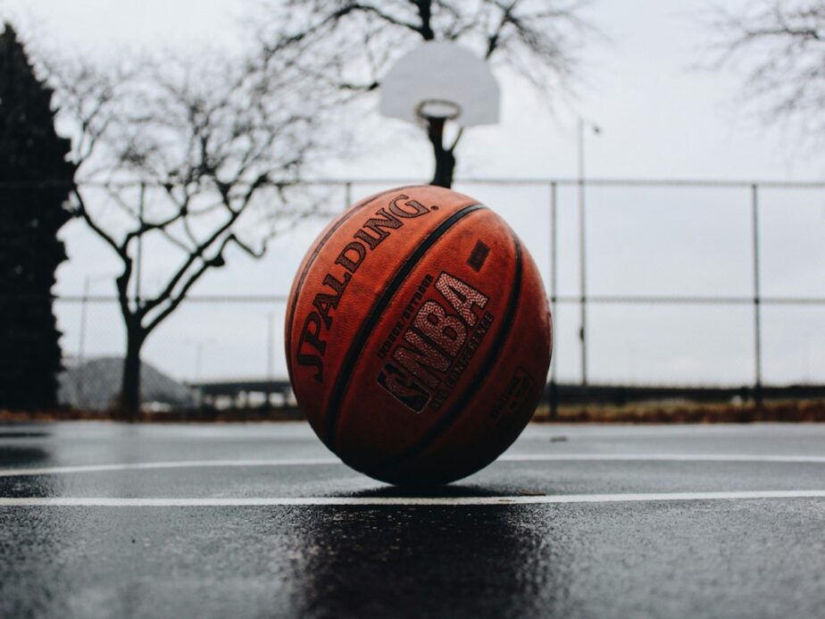 An NBA basketball sitting outside on a basketball court.