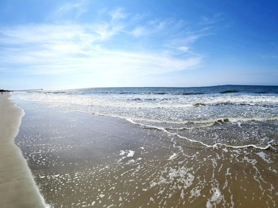 The ocean and blue skies along the beach of Oak Island.