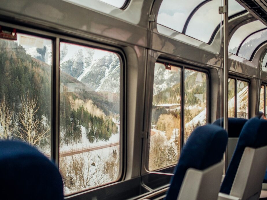 An Amtrak train with snowy mountain views.