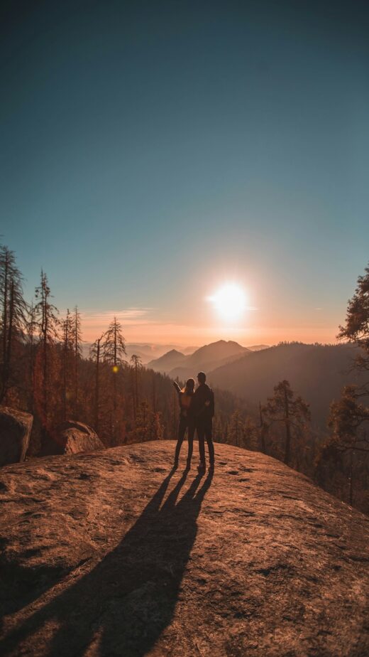 A couple hiking together during sunset.