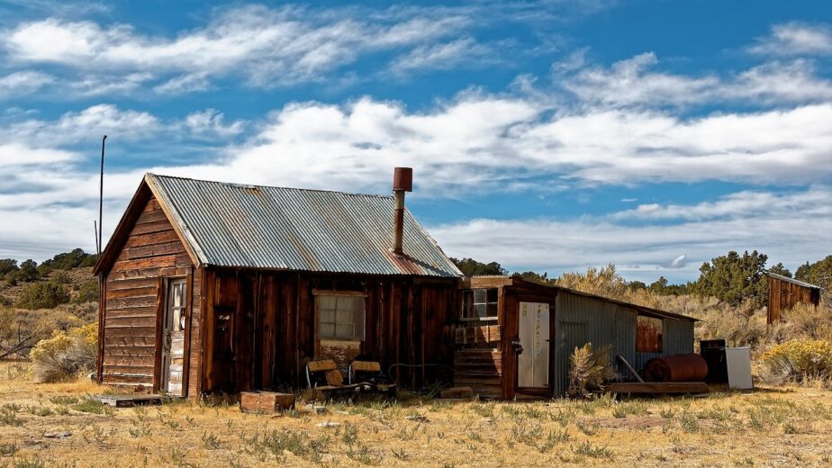 A ghost town sitting in a field.