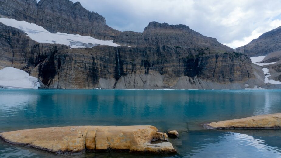 A glacier in Montana with rocks and mountains.