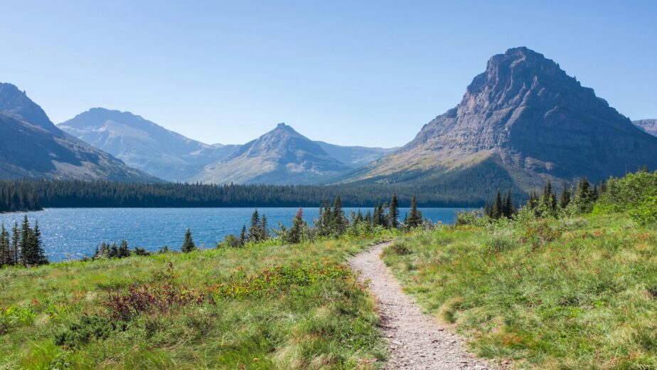 A lake and mountains with a hiking trail leading throughout.