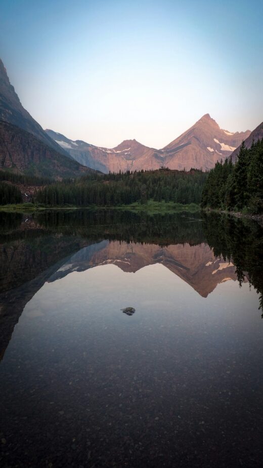 Mountains and a lake surrounded by green trees in Montana.