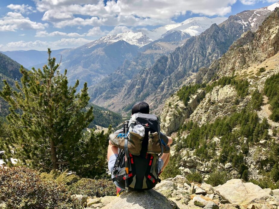 A hiker looking out at the mountains on a hike.