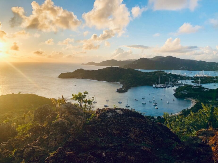 The mountains and islands in Antigua with sailboats in the water.