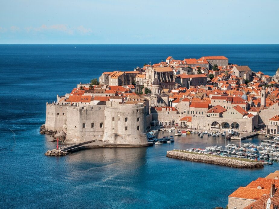 Dubrovnik sitting by the sea with blue skies.