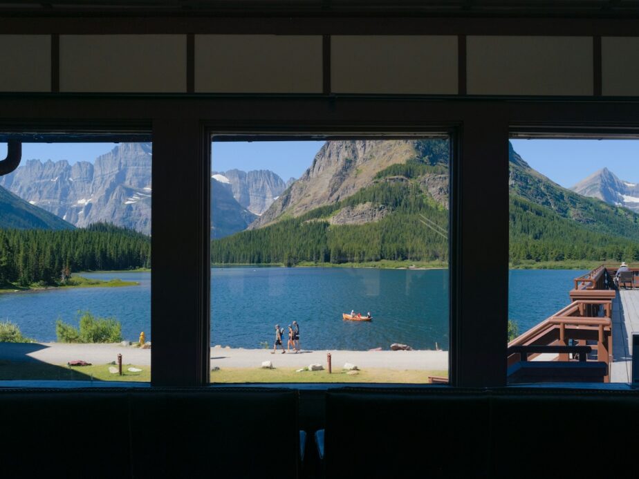 Glacier National Park with its mountains and lake from inside a building.