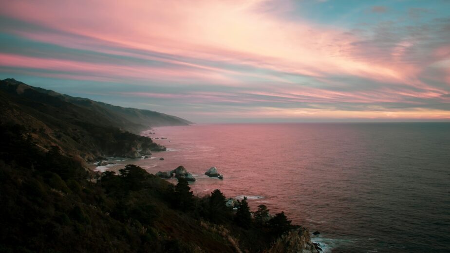 A pink sunset over the ocean along the Pacific Coast Highway.