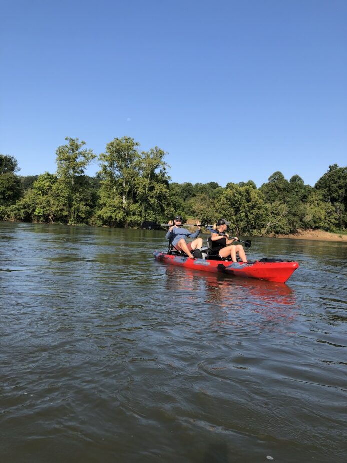 Abby and Sam kayaking along the James River, one of the best things to do in Lynchburg, Virginia.